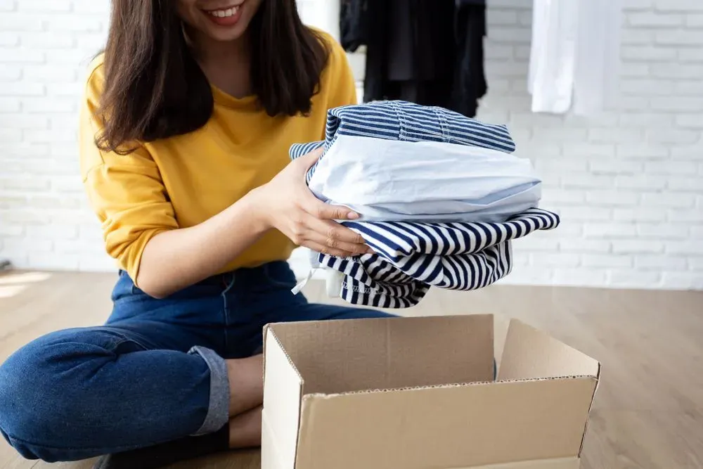 woman donating clother for end of year closet organization