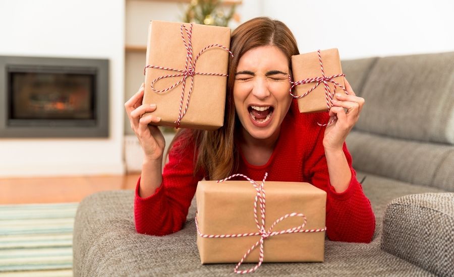 woman holding gifts and screaming
