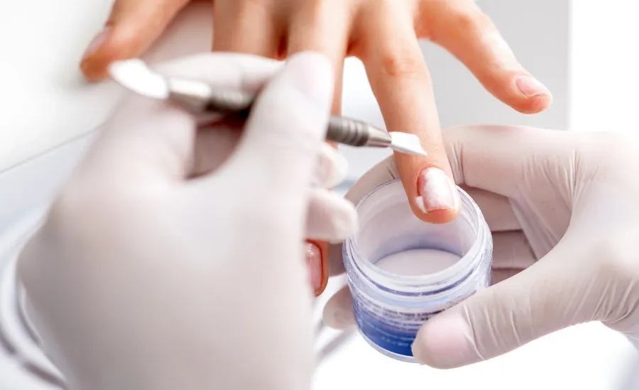 nail technician paints nails