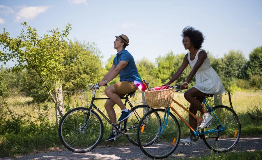 man and woman biking in nature