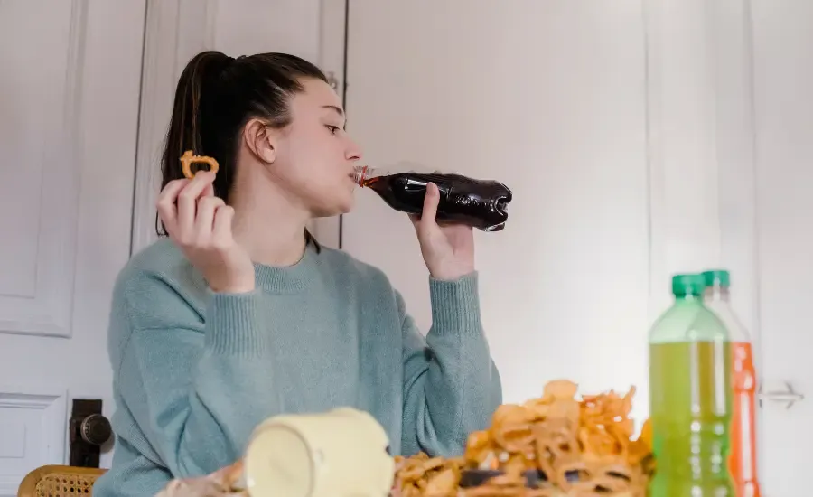 woman eating unhealthy food due to stress